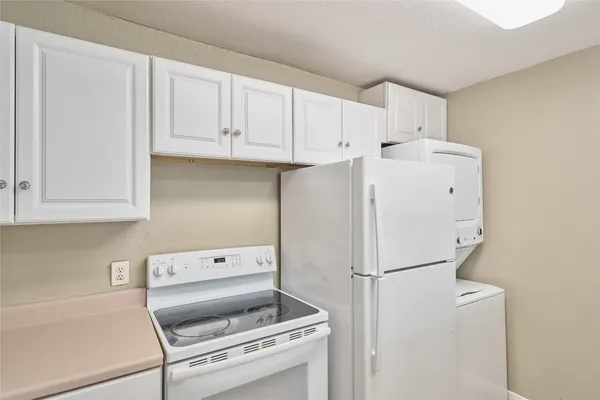 a white refrigerator freezer sitting inside of a kitchen