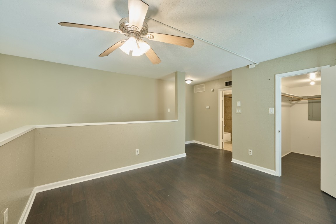 16120 Stuebner Airline Road, Unit 212 Spring, TX 77379 - Photo 27 of 29 an empty room with wooden floor and fan