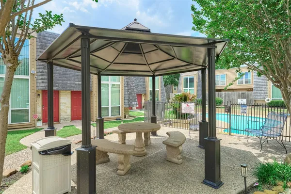 a patio with table and chairs