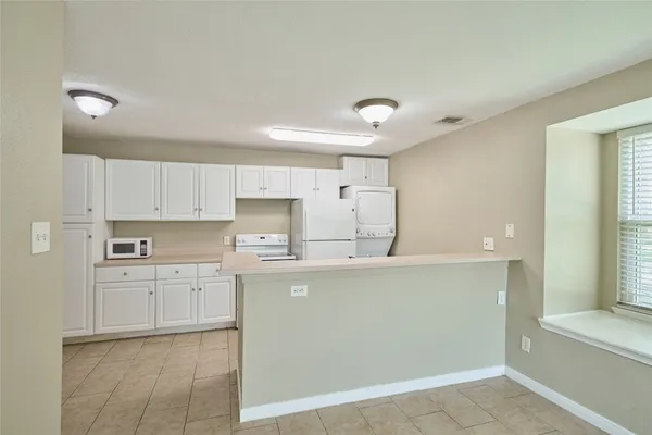 a kitchen with cabinets and white appliances