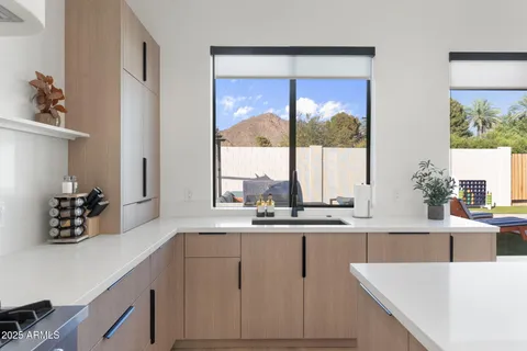 a kitchen with a sink and large window