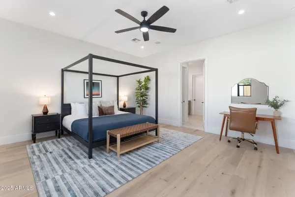 a bedroom with furniture and a wooden floor