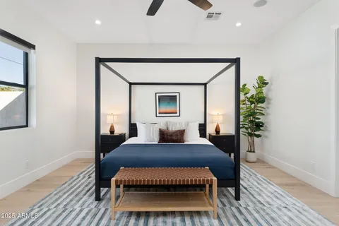 a bedroom with a bed and a potted plant