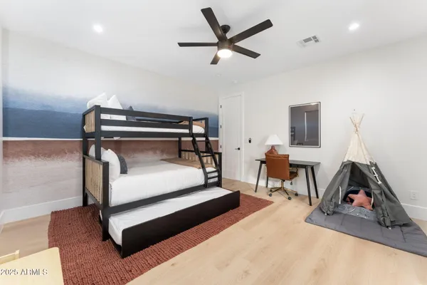 a bedroom with furniture and a ceiling fan