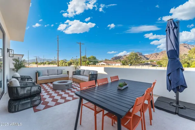 a outdoor dining space with furniture and a potted plant