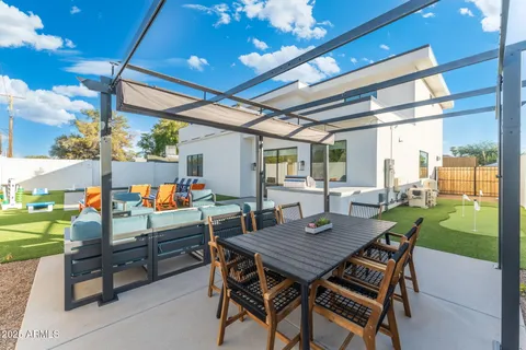a view of a dining room with furniture and a patio
