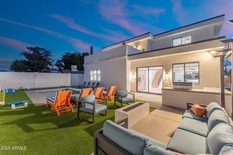 a outdoor sitting area with furniture and wooden floor