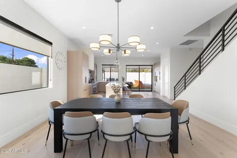a view of a dining room with furniture and a chandelier