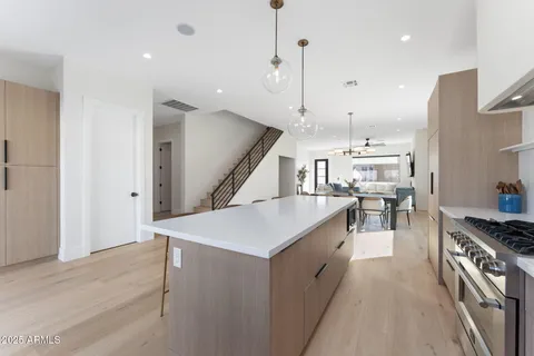 a kitchen with stainless steel appliances kitchen island a large island in the center