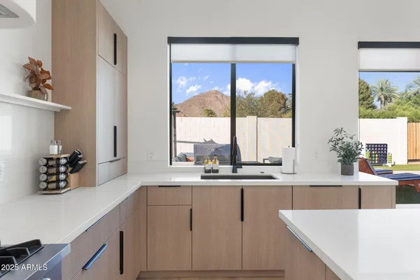 a kitchen with a sink and large window