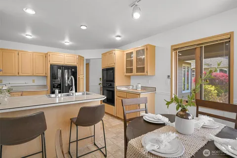 a kitchen with stainless steel appliances kitchen island granite countertop a sink and cabinets