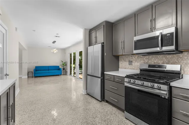 a kitchen with stainless steel appliances a refrigerator stove and microwave