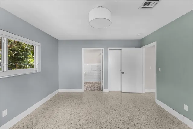 a view of an empty room with a window