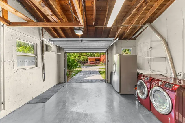 a view of a backyard with table and chairs and wooden fence