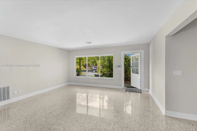a view of an empty room with a window