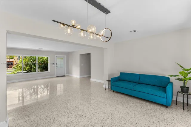 a view of a livingroom with furniture and a large window