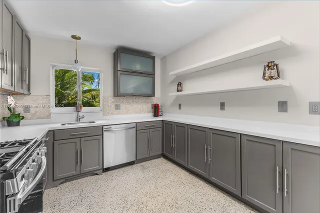 a kitchen with sink cabinets and window