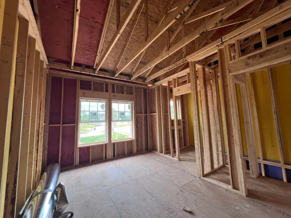 a view of an empty room with wooden walls