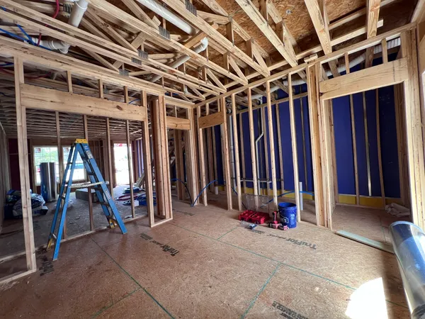 a view of a room with chairs and door