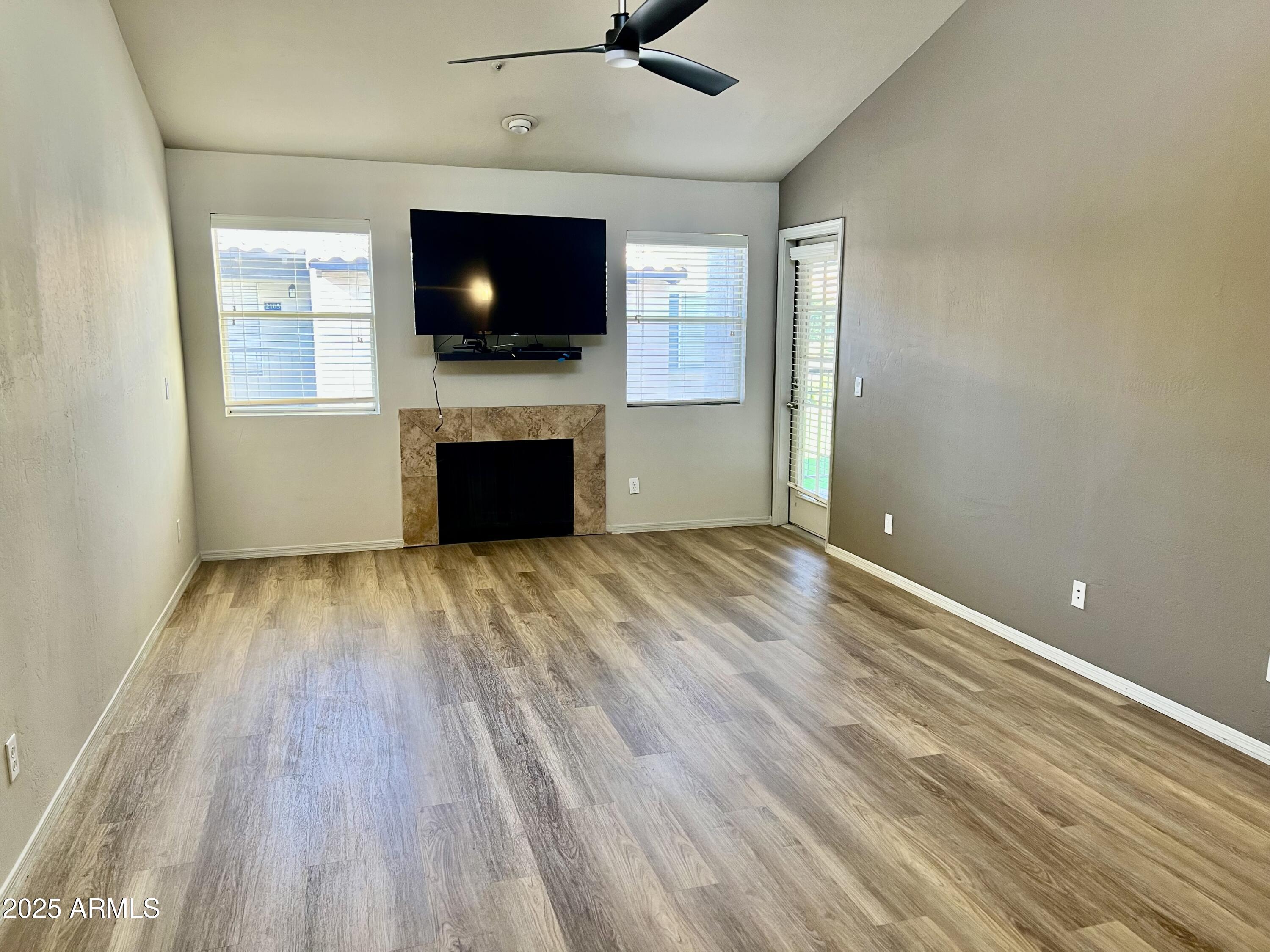 14145 North 92nd Street, Unit 2101 Scottsdale, AZ 85260 - Photo 12 of 30 a view of a livingroom with wooden floor and a fireplace