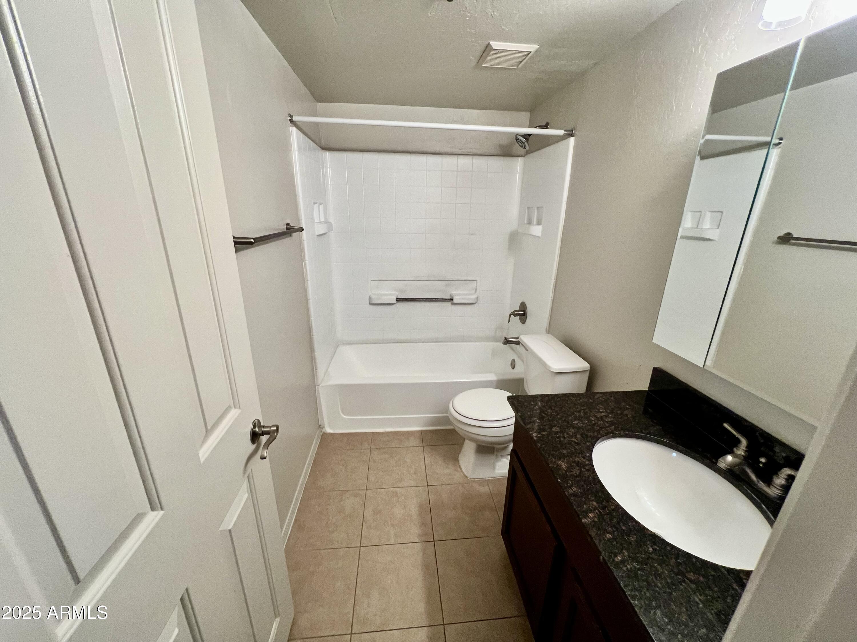 14145 North 92nd Street, Unit 2101 Scottsdale, AZ 85260 - Photo 15 of 30 a bathroom with a granite countertop sink toilet and shower