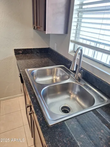 a kitchen with stainless steel appliances granite countertop a sink a stove microwave and cabinets