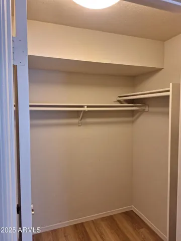 a view of a room with wooden floor and white walls