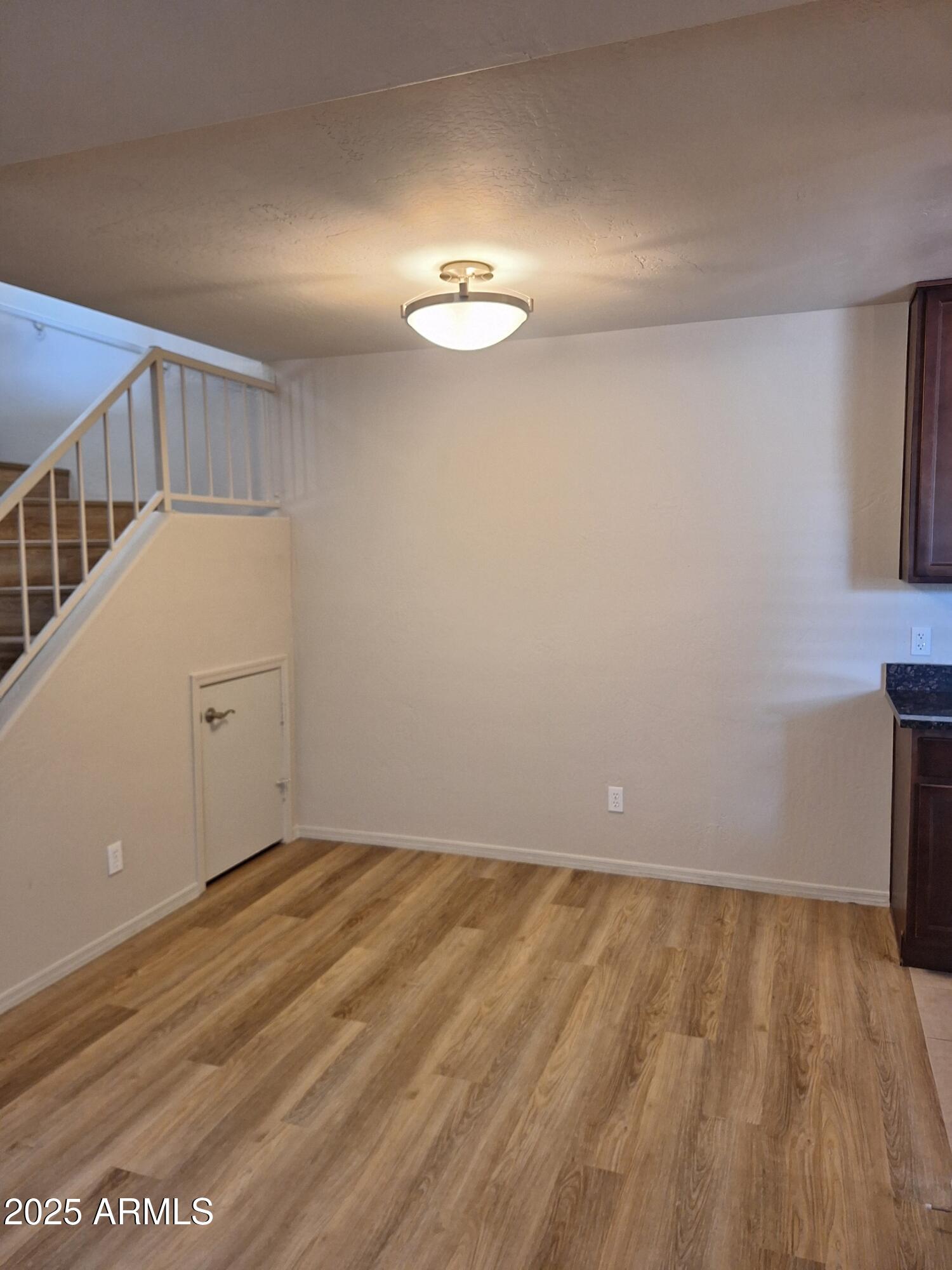 14145 North 92nd Street, Unit 2101 Scottsdale, AZ 85260 - Photo 25 of 30 a view of a room with wooden floor and white walls