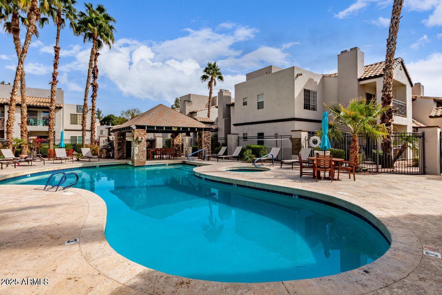 14145 North 92nd Street, Unit 2101 Scottsdale, AZ 85260 - Photo 27 of 30 a view of a swimming pool with a patio
