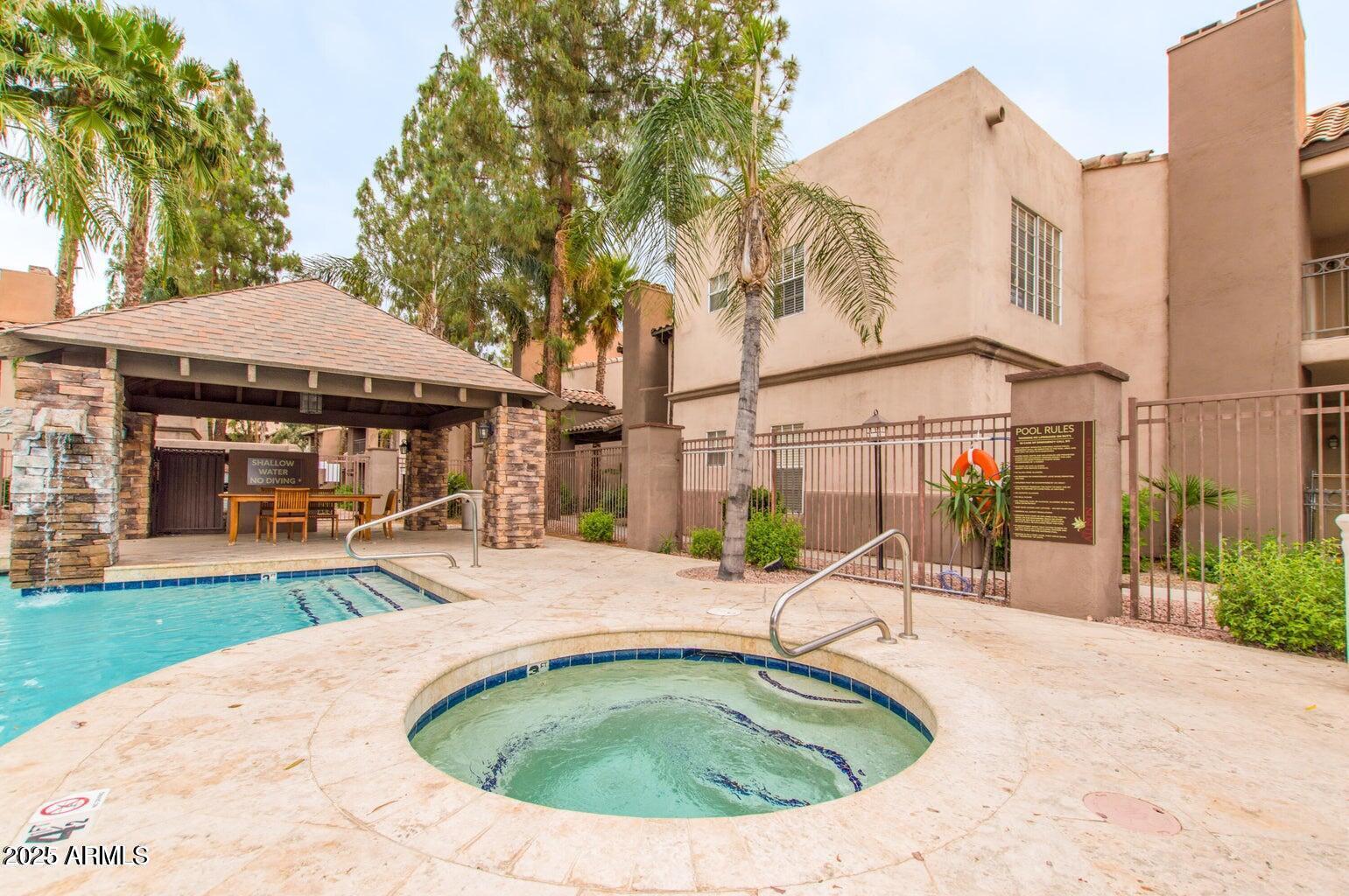 14145 North 92nd Street, Unit 2101 Scottsdale, AZ 85260 - Photo 28 of 30 a view of a house with backyard porch and sitting area