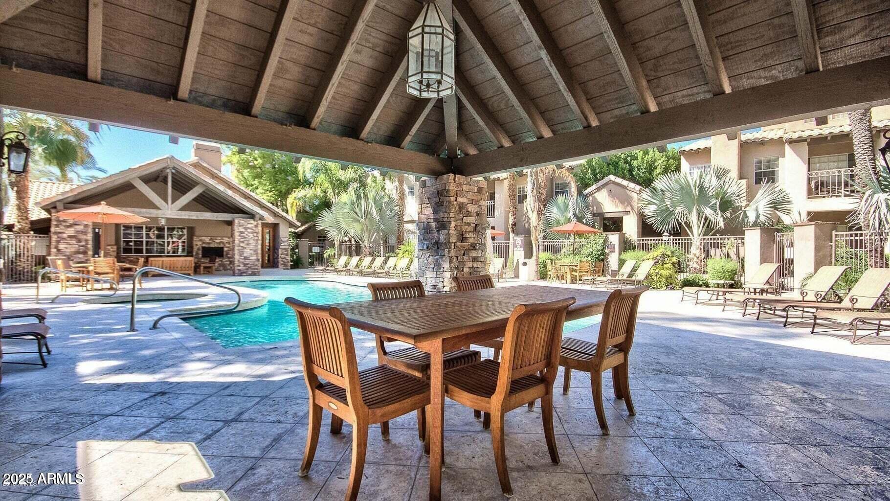 14145 North 92nd Street, Unit 2101 Scottsdale, AZ 85260 - Photo 5 of 30 a view of an outdoor space with a table and chairs