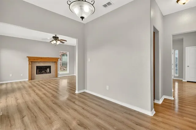 wooden floor in an empty room with a fireplace