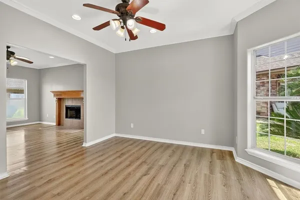 wooden floor in an empty room with a window