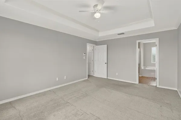 a view of an empty room with a fan