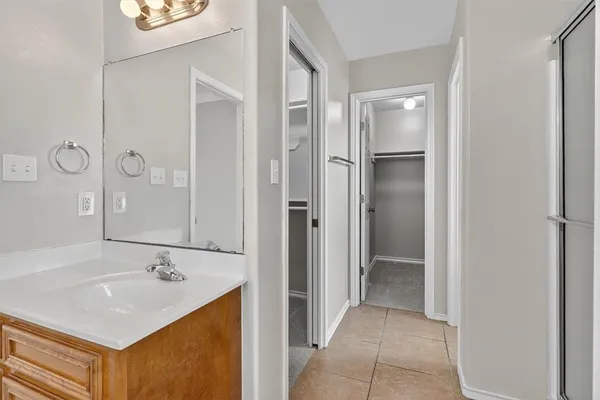 a bathroom with a sink a mirror and a shower