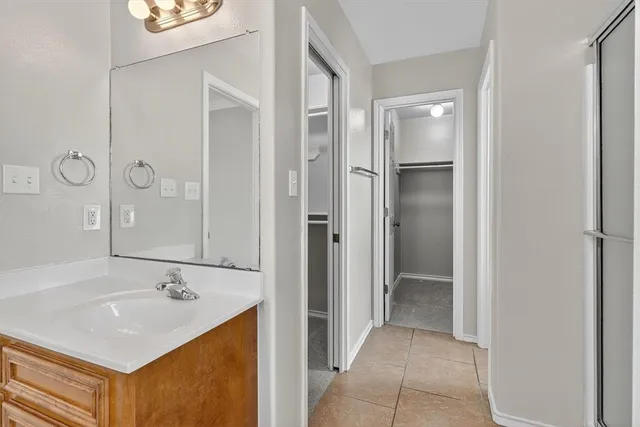 a bathroom with a sink a mirror and a shower