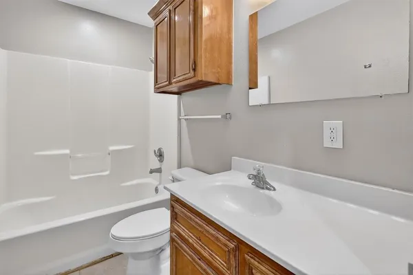 a bathroom with a sink a toilet and bathtub