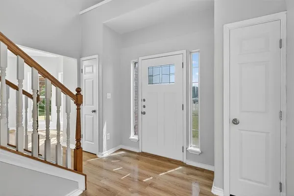 a view of an entryway with wooden floor