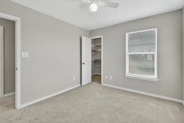 an empty room with windows and closet