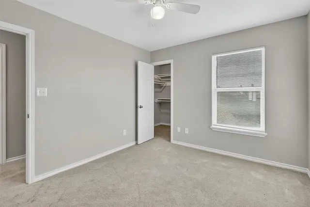 an empty room with windows and closet