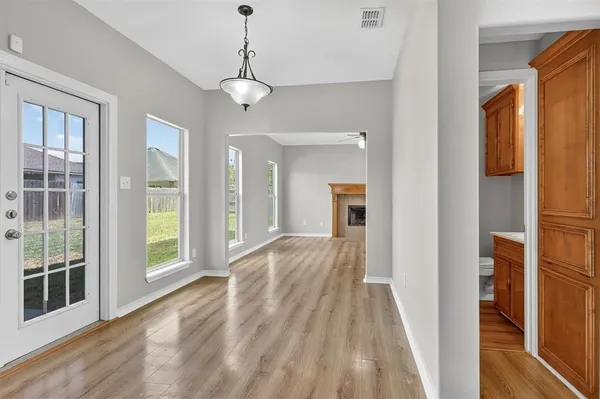 a view of a room with wooden floor and windows