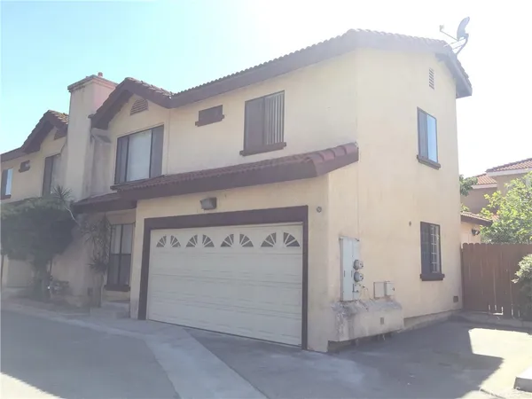 a view of a house with white door and a outdoor space