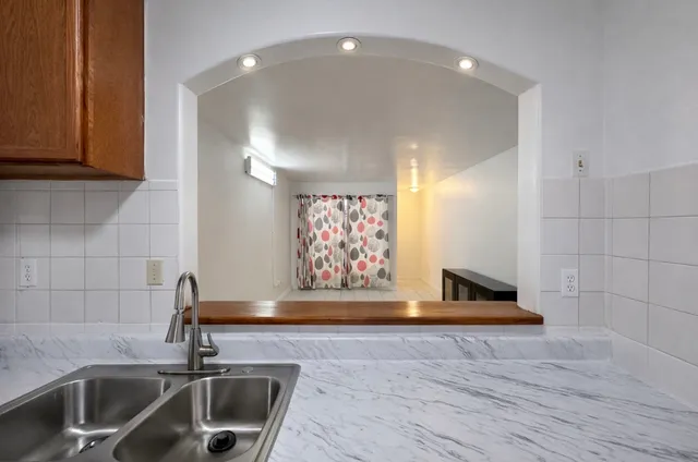 a kitchen with a refrigerator and a stove