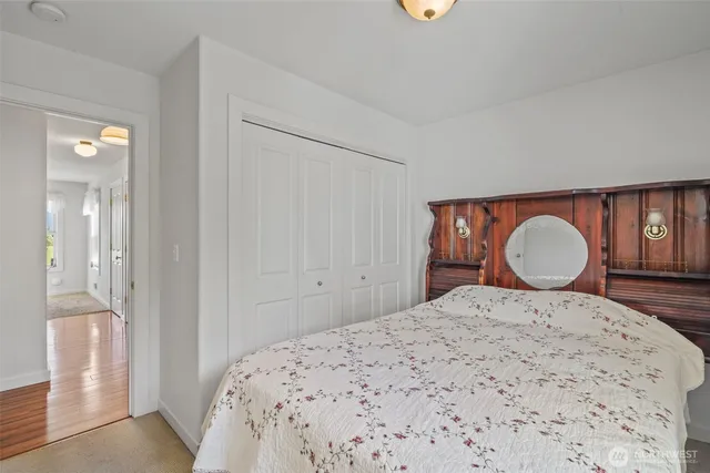 a bedroom with a bed and a large mirror