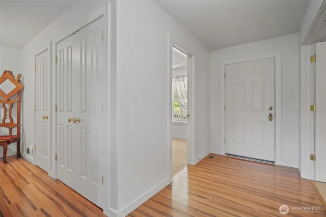a view of a hallway with wooden floor