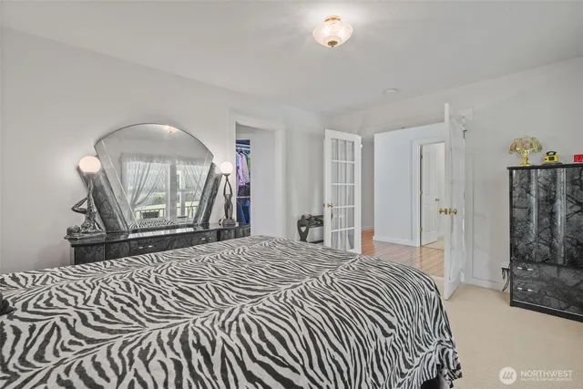 a bedroom with a bed and a mirror