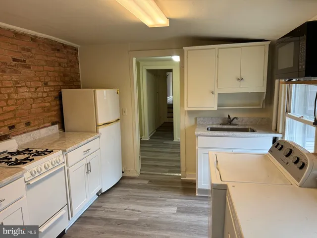 a kitchen with a refrigerator stove and cabinets
