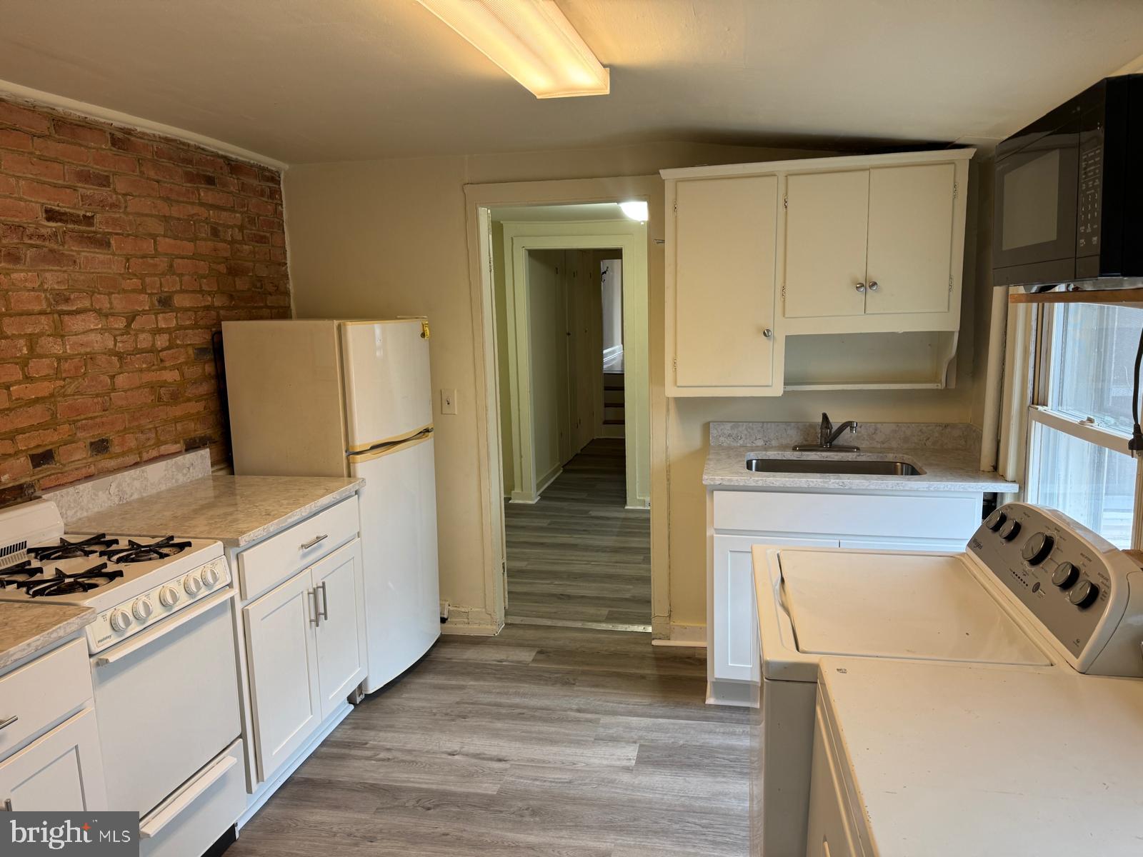 230 West Lafayette Avenue, Unit 3 Baltimore, MD 21217 - Photo 15 of 19 a kitchen with a refrigerator stove and cabinets
