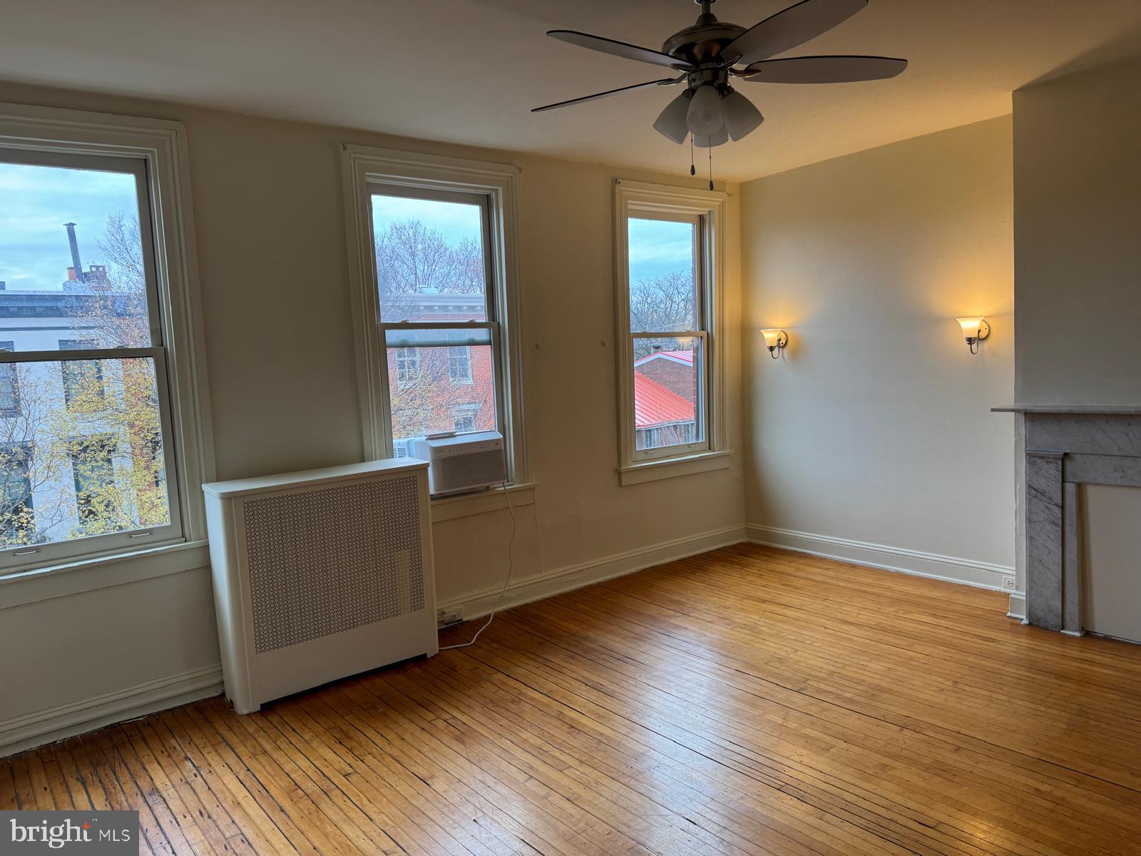 230 West Lafayette Avenue, Unit 3 Baltimore, MD 21217 - Photo 5 of 19 a view of an empty room with window and wooden floor
