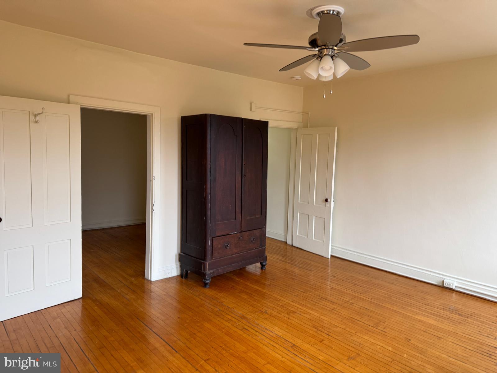 230 West Lafayette Avenue, Unit 3 Baltimore, MD 21217 - Photo 7 of 19 an empty room with wooden floor closet and windows